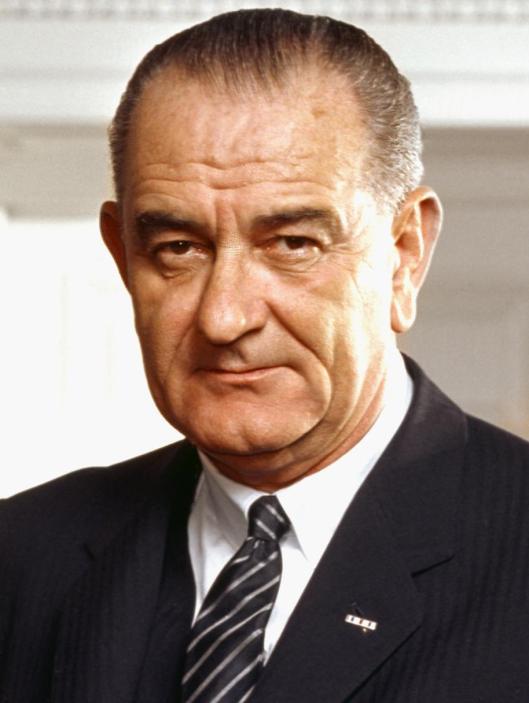 Photo portrait of President Lyndon B. Johnson [our last transformational President] in the Oval Office, leaning on a chair, March 10, 1964. (Arnold Newman, White House Press Office via Wikipedia). In public domain.