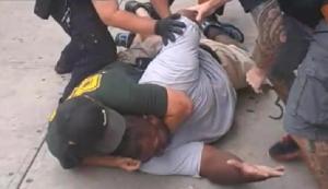 Eric Garner in midst of dying from choke-hold via NYPD's finest, Daniel Pantaleo and (not pictured)  and Justin Damico, Staten Island, NY, July 17, 2014. (http://www.thegrio.com).