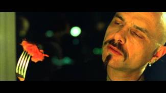 "Ignorance is bliss" scene screen shot from The Matrix (1999) with Joe Pantoliano as Cypher eating a Matrix steak, September 2, 2015. (http://chicagoboyz.net).