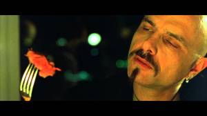"Ignorance is bliss" scene screen shot from The Matrix (1999) with Joe Pantoliano as Cypher eating a Matrix steak, September 2, 2015. (http://chicagoboyz.net).