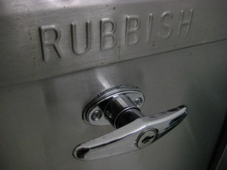 Standard New York-area garbage chute door, June 2009. (http://theferrisfiles.com/).