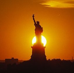 The Sun setting behind the Statue of Liberty, New York, July 4, 2003. (http://science.nasa.gov/).